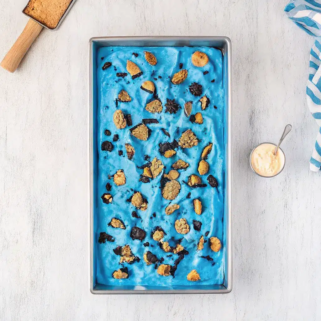 Cookie Monster Ice Cream: A Fun, Flavorful Treat for All Ages 3 Full tray of Cookie Monster ice cream topped with chocolate and cookie crumbles.