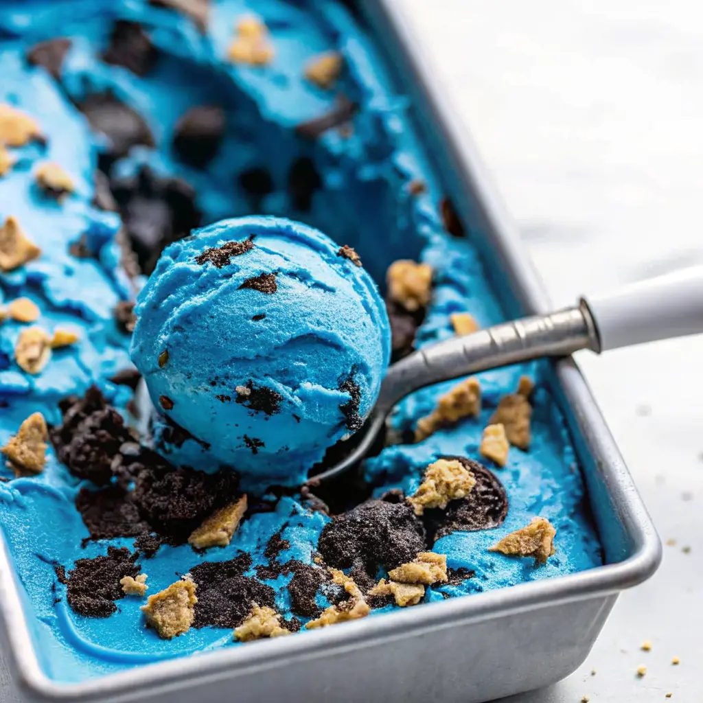 Cookie Monster Ice Cream: A Fun, Flavorful Treat for All Ages 2 Bright blue Cookie Monster ice cream scoop with cookie and Oreo crumbles.