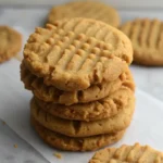 Close-up of a stack of peanut butter protein cookies with fork impressions