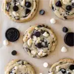 Cookie and Cream Cookies Recipe: Easy, Soft & Addictive Treats 5 Cookie and cream cookies loaded with dark and white chocolate chips next to mini Oreos