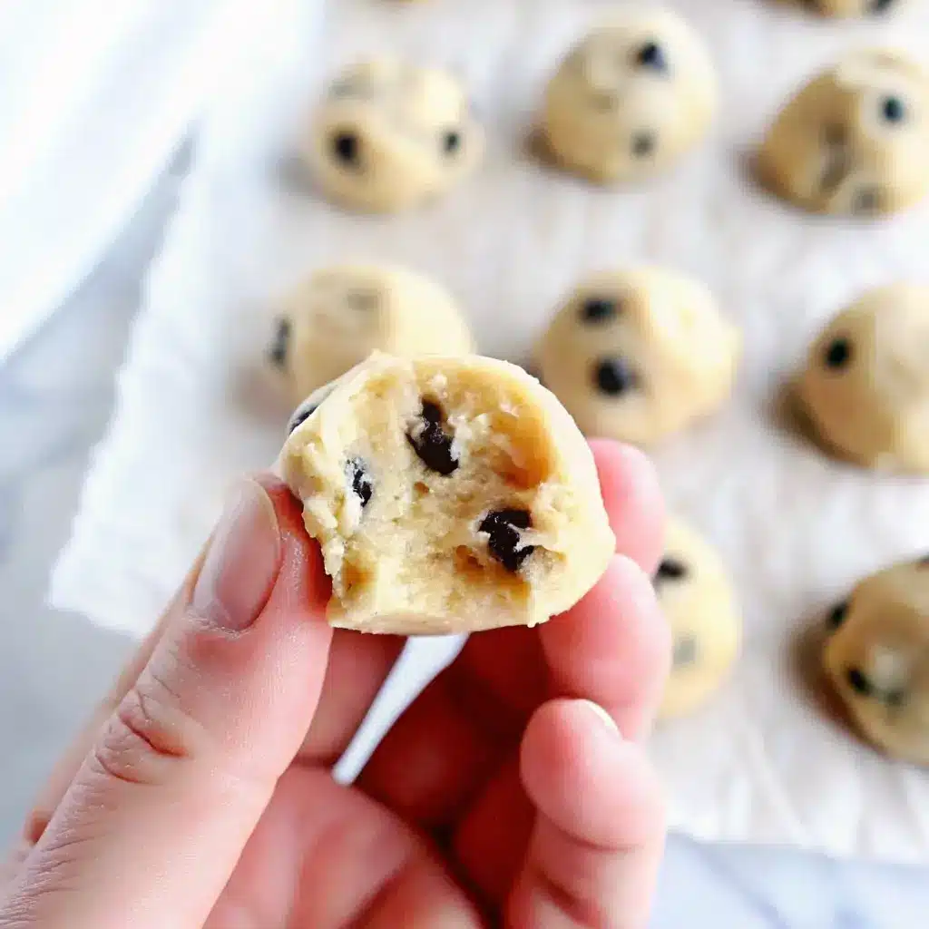 Cookie Dough Bites: Easy No-Bake Treat You Can Make at Home 6 Hand holding a bitten edible cookie dough ball with chocolate chips