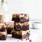 Cookie Dough Brownies: Easy Recipe for the Ultimate Dessert Lovers 5 Stack of three cookie dough brownies on parchment paper