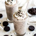 Cookies and Cream Protein Shake: The Creamy, Crave-Worthy Way to Boost Your Day 5 Cookies and cream protein shakes on a white background with cookies scattered around