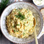 Cottage Cheese Egg Salad: A Healthy, Creamy Twist You’ll Love 5 Bowl of cottage cheese egg salad with herbs on a rustic surface