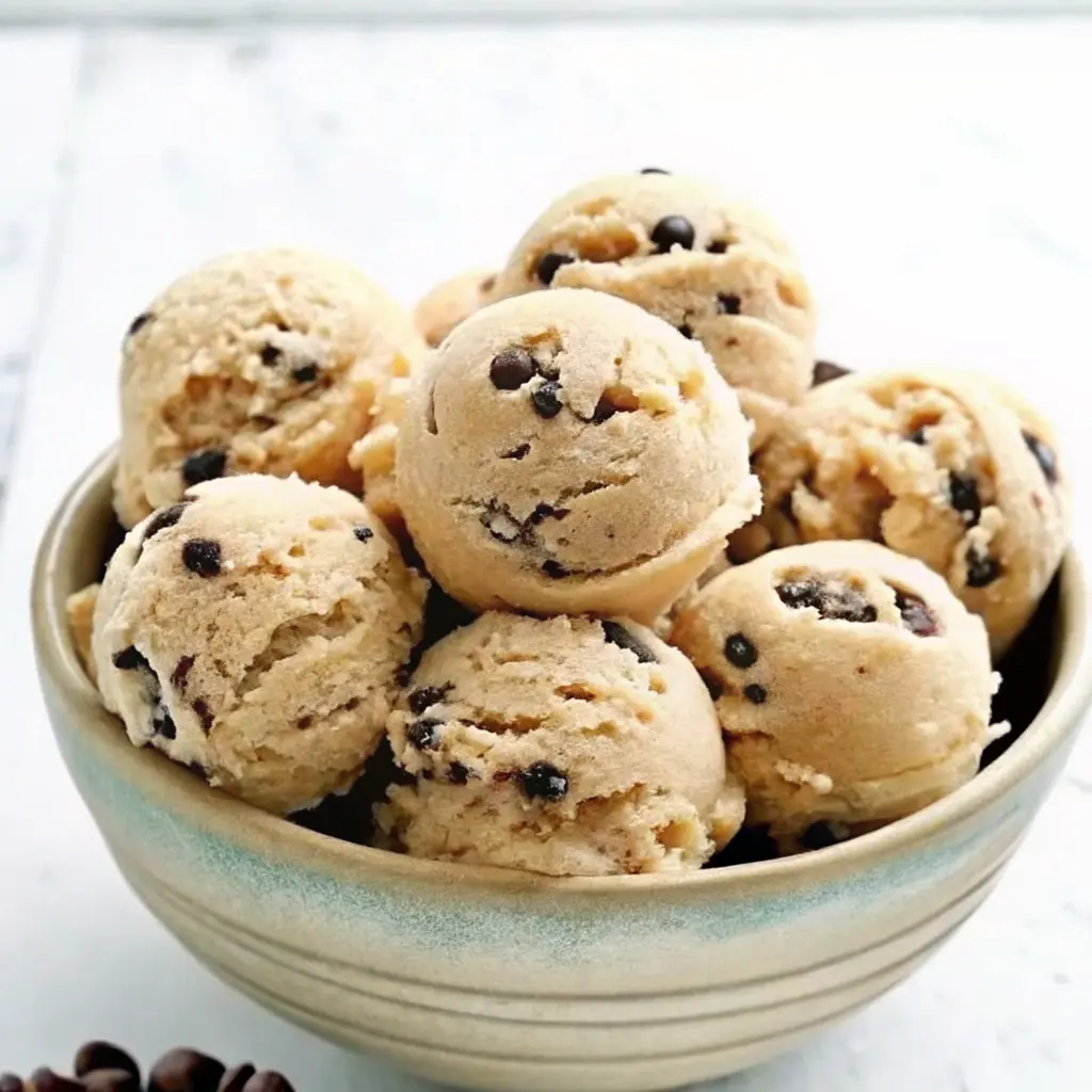 Gluten Free Cookie Dough – Easy, Safe, and Totally Delicious 4 Scoops of gluten-free edible cookie dough with chocolate chips in a ceramic bowl