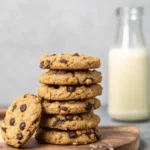 Sugar Free Chocolate Chip Cookies That Actually Taste Good 5 Pile of sugar-free chocolate chip cookies on a wooden plate beside milk