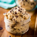 Edible cookie dough recipe for one in a glass jar topped with mini chocolate chips