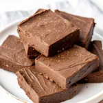 Cottage cheese fudge squares stacked on a white plate