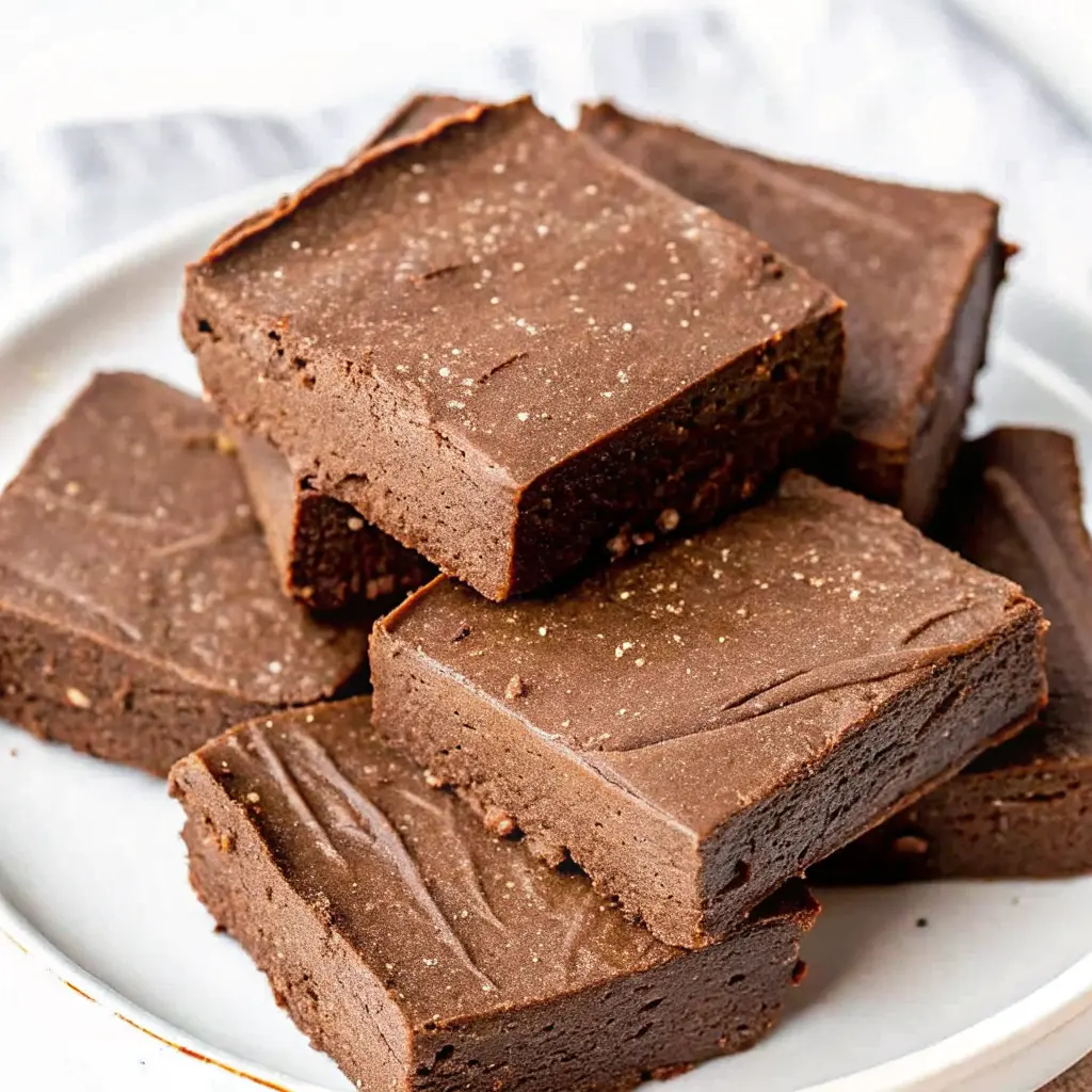 Cottage Cheese Fudge Recipe: Easy, High-Protein, Dessert-Like Treat 2 Cottage cheese fudge squares stacked on a white plate