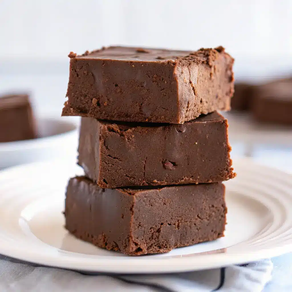 Cottage Cheese Fudge Recipe: Easy, High-Protein, Dessert-Like Treat 1 Thick slices of chocolate cottage cheese fudge stacked on a plate