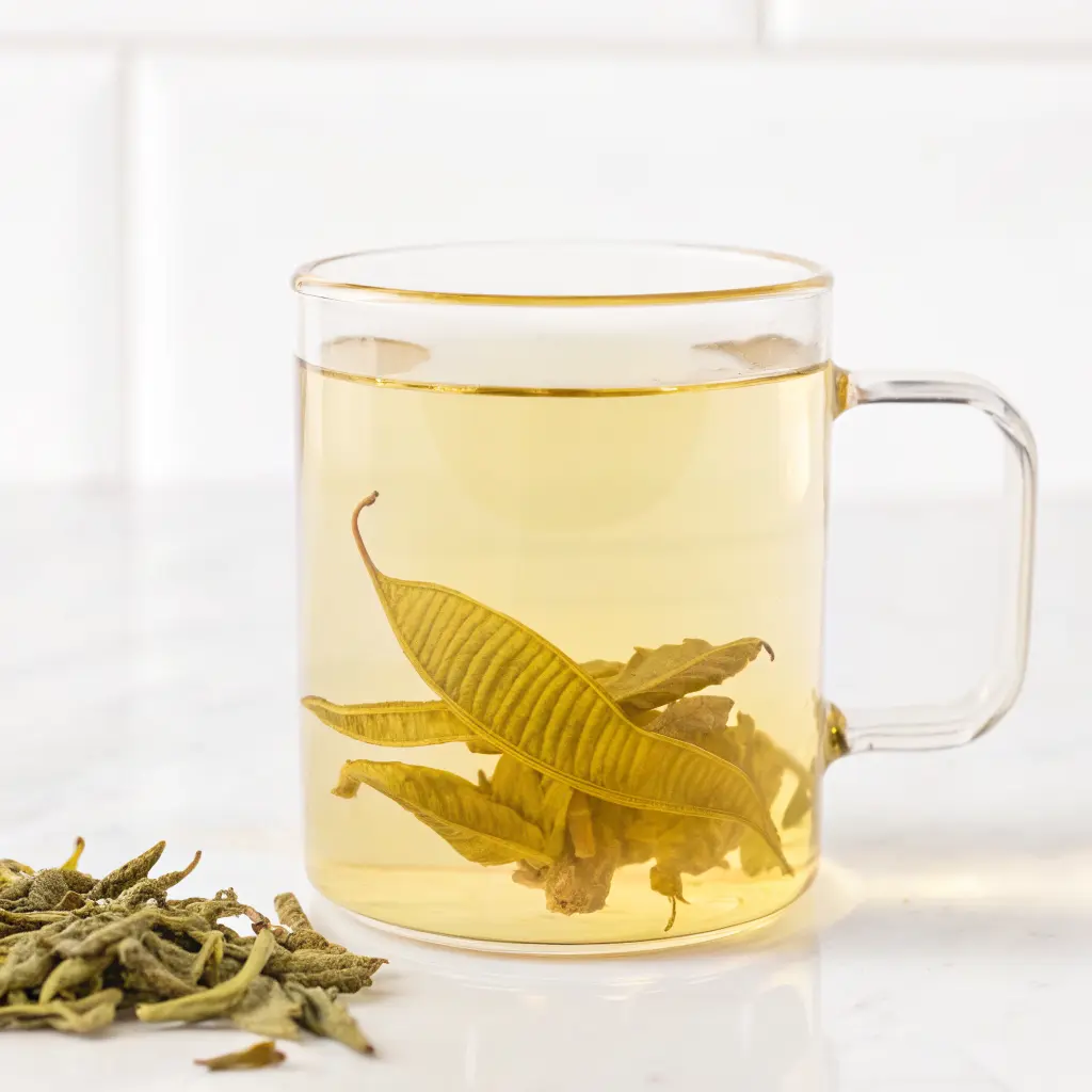 Lemon Verbena Tea Recipe: Soothing, Simple, and Full of Natural Benefits 1 Lemon verbena tea with dried leaves steeping in clear glass mug