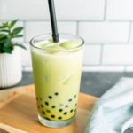 Refreshing glass of iced matcha green tea bubble tea with black tapioca pearls