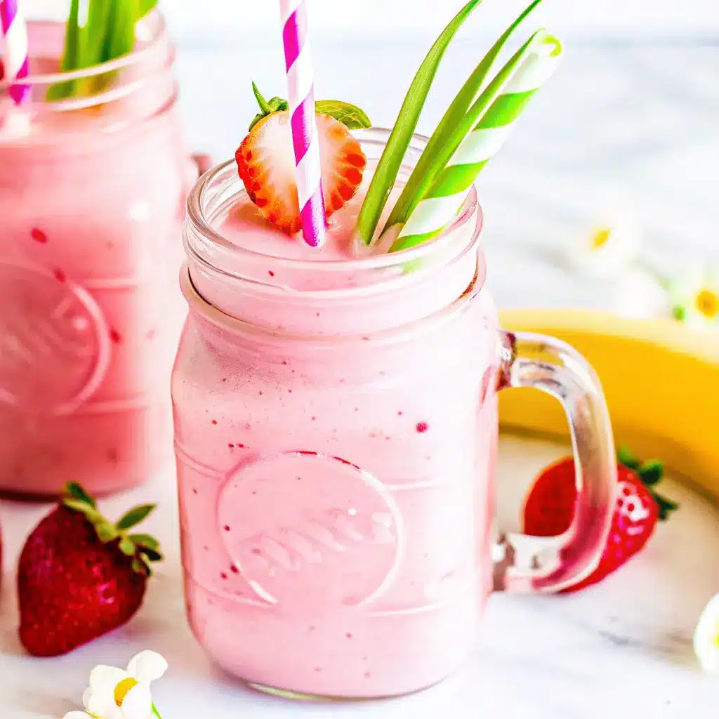 Bahama Mama Smoothie Tropical Smoothie Cafe: Easy Copycat Recipe 2 Bahama Mama smoothie tropical smoothie cafe in mason jar with fresh strawberry and striped straw